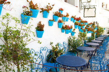 Typical terrace with forge furniture in a white village in Andalusia, Spain.