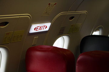 emergency exit sign on airplane, emergency door