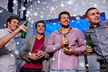 group of male friends with beer in nightclub