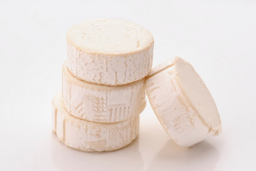 loop portions of goat cheese on white background