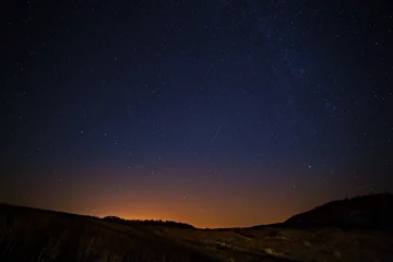 Keuken spatwand met foto The starry sky and Milky Way  above the lighted lanterns city. © lexuss