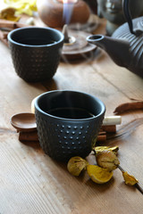 cups of black tea accompanied by incense ,