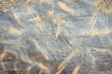 Metal textured surface with yellow scratches and cracks on black