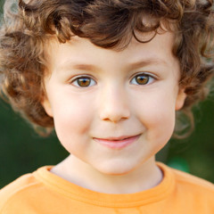 Nice portrait of a little boy with curly hair and brown eyes