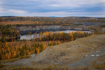 View of the dumps and flooded quarry near the town of Nizhny Tagil, Sverdlovsk region, autumn