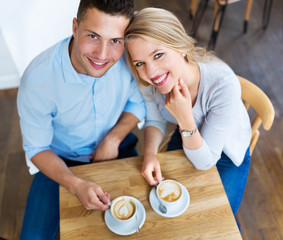 Obraz na płótnie Canvas Couple drinking coffee in cafe