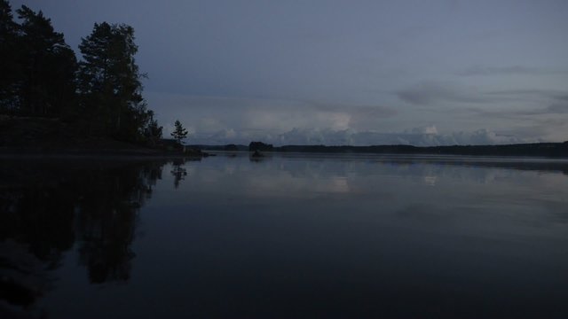 Gentle waves during a sunset over a lake in Sweden during summer.