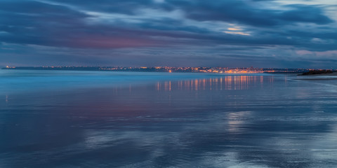 Magical panorama seascape reflection town water. In shades of blue Armacao de Pera.