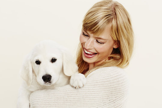Young woman with puppy in studio