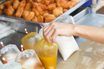 Asian woman's hand Choosing healthy  pumpkin juice, Thailand str