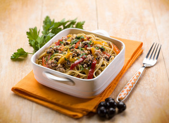 spaghetti with tuna capers olives and peppers, selective focus