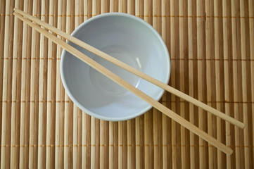 bol et baguettes chinoises sur set de table en bambou