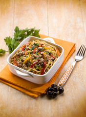 spaghetti with tuna capers olives and peppers, selective focus