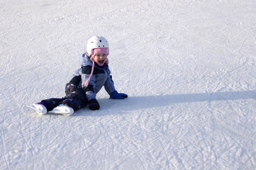 Fototapeta na wymiar A Young Skater sitting on ice