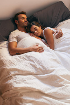 Young Couple Sleeping in Bed with Morning Light