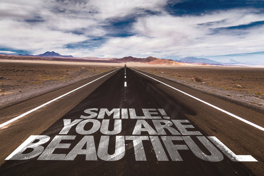 Smile! You Are Beautiful written on desert road