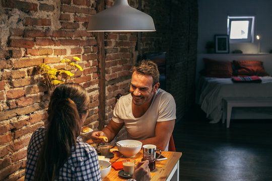 Young Couple Having Breakfast in a Rustic Apartment