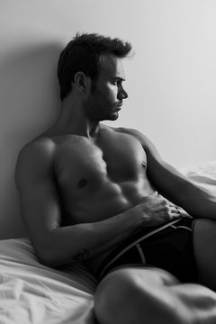 Sexy Man Sitted on a Bed