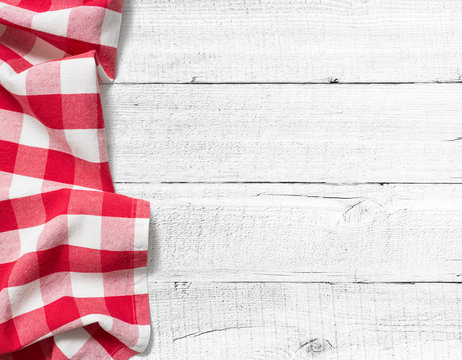 checked picnic tablecloth on white wood table background