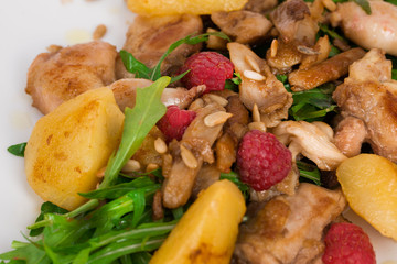 Chicken duck salad with arugula, raspberries, potatoes