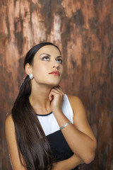 Fototapeta premium Beauty portrait of young brunette woman, isolated on gray backgr