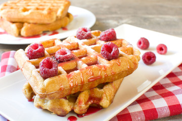 Waffles with raspberries and strawberry syrup