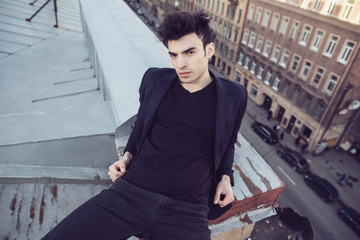 Fashion businessman on a rooftop in the center of the city