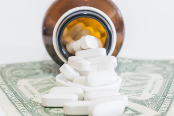 White Pills and Money on white background