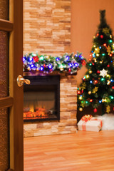  room with an electric fireplace and a Christmas tree