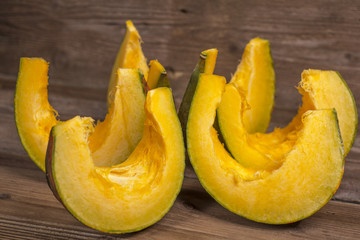 Pumpkins slices on wooden background