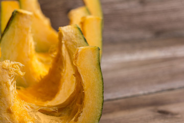 Pumpkins slices on wooden background