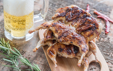 Grilled quails with glass of beer