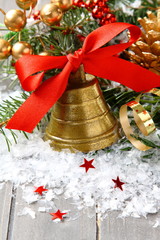 Golden bell with red ribbon bow and christmas decoration