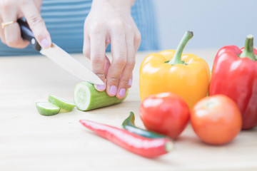 Salad preparation - cutting fresh vegetables into pieces