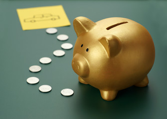 Dream car savings - golden piggy bank, coins and a car sketch