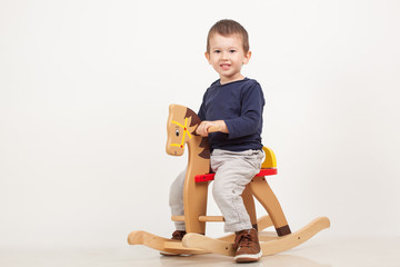 little boy on a rocking horse.