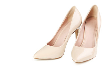 Pair of beige women's high-heeled shoes isolated on a white