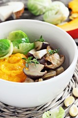 Fried wild mushrooms with pumpkin puree and Brussels sprouts.Selective focus