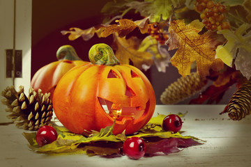 Naklejka na ściany i meble pumpkins and autumn leaves on wooden background