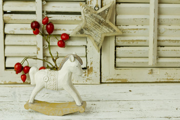 Fototapeta na wymiar wooden rocking horse on a wooden rustic background