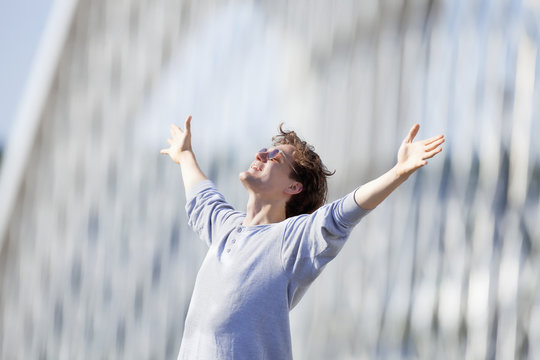 Excited Young Man Stretching out his Arm in Emotion