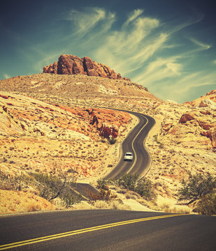 Retro toned curved desert highway, travel adventure concept, USA