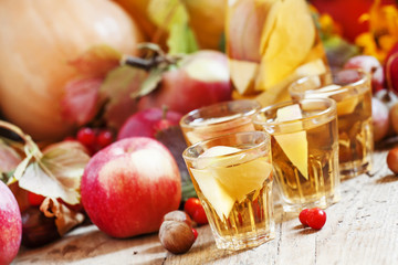 Apple cider in the autumn background, selective focus