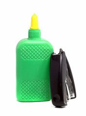 bottle of glue and old stapler on a white background