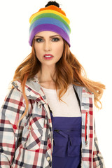 woman with red hair in coveralls and hat stand close