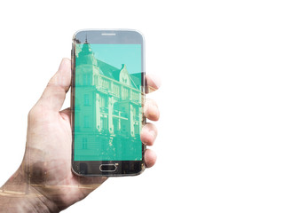 Double exposure of hand with smart phone, city street
