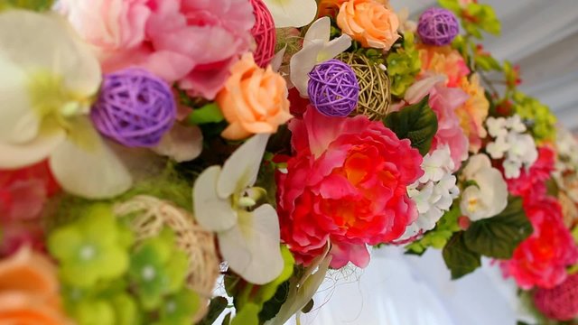 Beautiful details of place for outside wedding ceremony. Wedding floral decor. Close up of artificial flowers.