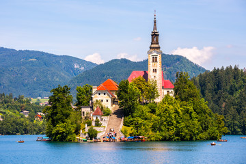 Famous Catholic Church on Island in the Middle of Bled Lake with Tourists and Boats