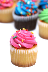Multicolored Cupcakes Isolated on a White Background