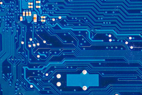 blue circuit board background of computer motherboard close up